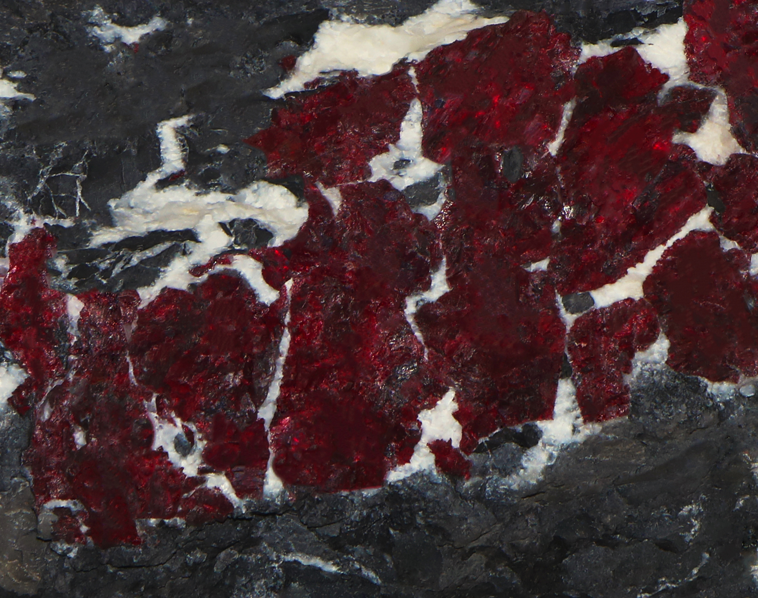 Shining cinnabar vein in grey stone texture